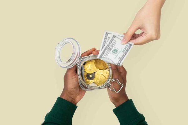 money-jar-held-by-hands-finance-savings-concept